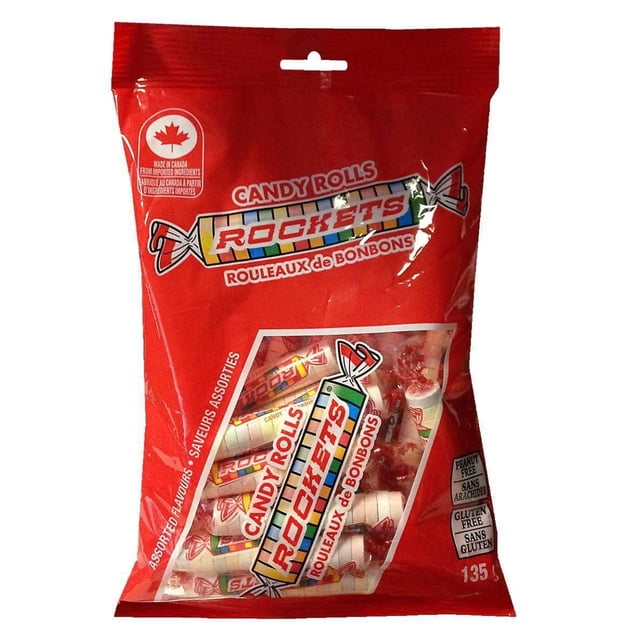 ROCKETS Candy Rolls in a red bag containing assorted fruity hard candy rolls with white wrappers printed with colorful stripes and the ROCKETS logo, made in Canada, peanut free and gluten free, suitable for parties, birthdays, and Halloween treats.