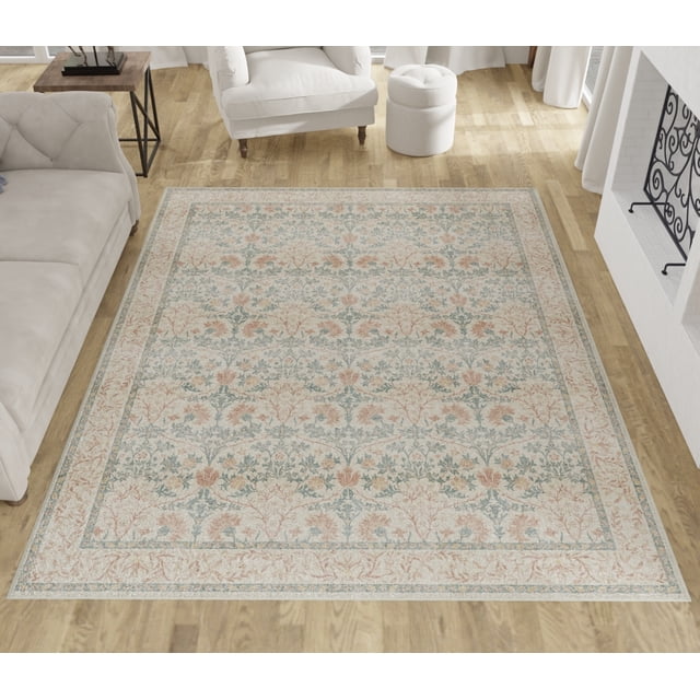 E-Z Wash Washable Area Rug for Living Room and Bedroom, Everbloom Lace, Burnt Umber, 8' x 10' featuring a lace-inspired floral pattern in burnt umber and soft blue on a cream background, placed on hardwood flooring in a living room with neutral sofas, a white armchair, and a fireplace with a black wrought iron screen, ideal for adding warmth and style to living or bedroom areas.