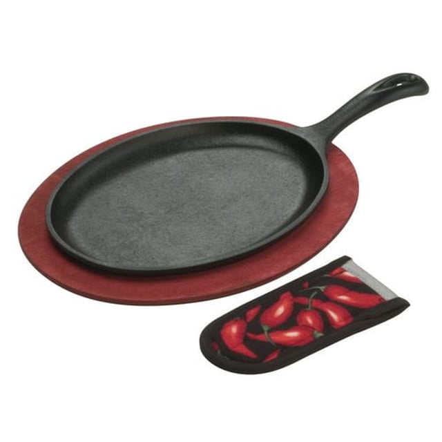 Lodge® Cast Iron Fajita Set featuring an oval cast iron griddle, a red-stained wooden underliner, and a chili pepper-patterned hot handle mitt. The griddle is pre-seasoned and ready to use, designed for even heating and maintaining food warmth. Suitable for all stovetops, ovens, and grills. Made in the USA.