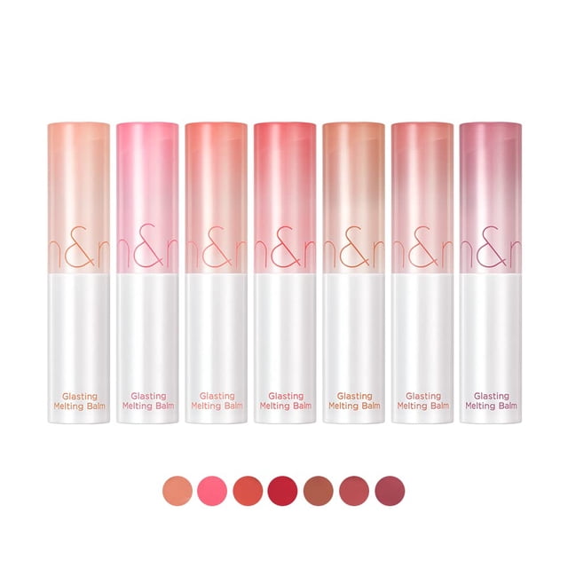 ROM&ND Glasting Melting Balm #04 Hippie Berry (3.5g) displayed alongside six other shades in a gradient arrangement. The lip balms feature a sleek, cylindrical design with a transparent cap and white base. This vegan-friendly balm is enriched with botanical oils like argan, rosehip, and evening primrose, offering a glossy, moisturizing finish. The formula provides vibrant, high-pigment colour with a dewy, transparent shine.