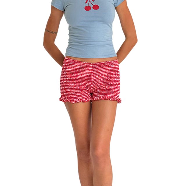 SUNSIOM Women's Shirred Shorts Casual Elastic Waist Solid Color Ruffled Short Pants for Summer in a red gingham pattern. These women's summer shorts feature a shirred texture, ruffled hem, and elastic waistband, styled with a light blue cherry-print top. Perfect for casual summer outings or vacations.