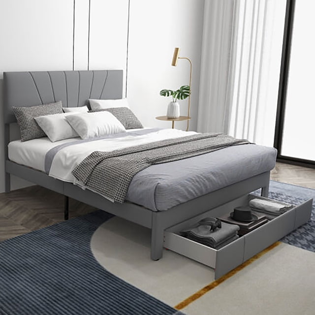 Gymax Queen Upholstered Bed Frame Platform Bed with Drawer & Adjustable Headboard in grey. The bed features a soft linen fabric headboard adjustable to two heights (45''/48.5''), a sturdy wooden slat base with extra middle support legs, and a pull-out drawer with wheels for convenient storage. The bed frame measures 84.5'' x 60.5'' and includes 8.5'' of under-bed clearance. Shown in a modern bedroom setting with bedding and decor.