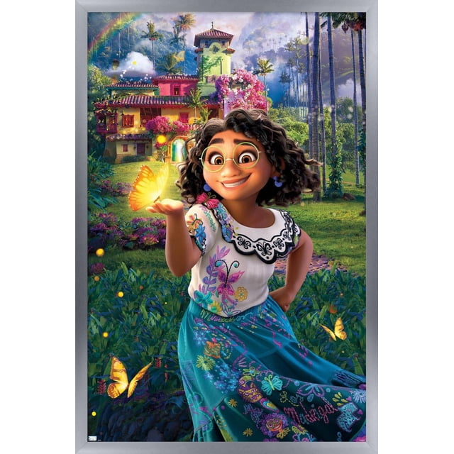 Disney Encanto - One Sheet Wall Poster, 22.375" x 34" depicting a young girl wearing a white blouse with black embroidered collar and colorful floral embroidery, paired with a blue skirt featuring vibrant patterns. She holds a glowing yellow butterfly on her hand amid lush greenery, butterflies, and a colorful multi-story house with pink and yellow walls, tall palm trees, and a rainbow in the sky.