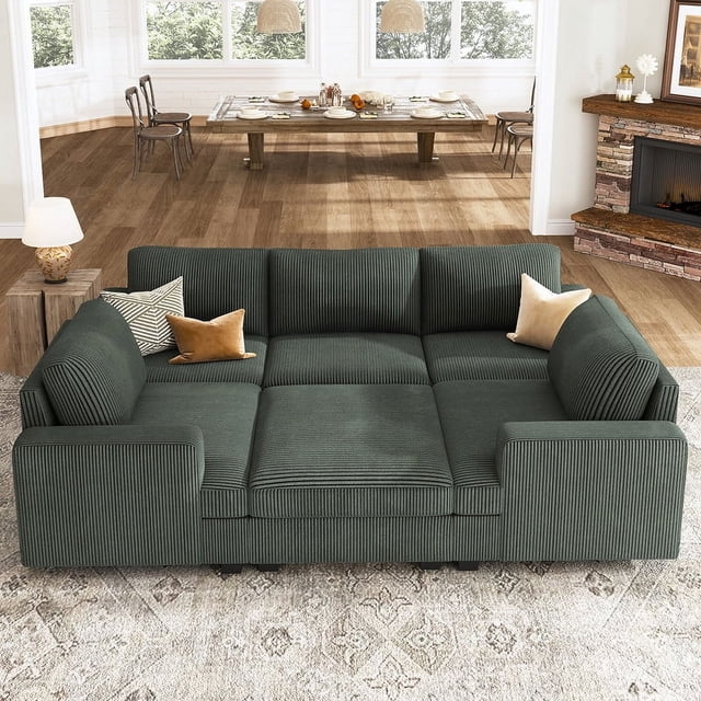 HONBAY Sectional Couch with Storage Ottoman, a green corduroy sleeper sectional sofa with chaise, designed for living room furniture sets. Features modular design for flexible arrangements, ample storage in the ottoman, and removable, washable covers for easy cleaning. Displayed in a warm living room with a fireplace and dining table in the background.