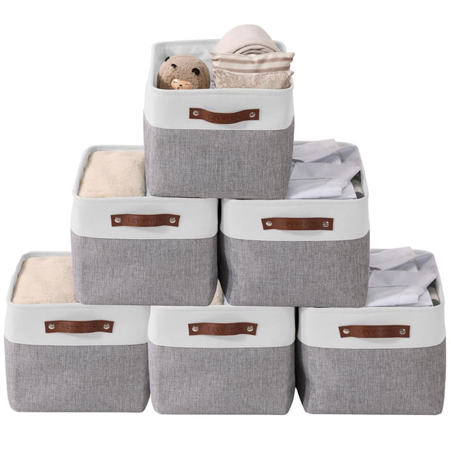 DECOMOMO 6-Packs Large Foldable Storage Bin with Handles, featuring a dual-colour grey and white design with durable faux leather handles. The bins are shown stacked in a pyramid arrangement, with some containing items like towels, a stuffed toy, and folded fabric. Each bin measures 15 inches (L) x 11 inches (W) x 9.5 inches (H) and is made with a sturdy MDF baseboard, thick EVA fabric, and a metal frame for stability. Ideal for organizing shelves, nurseries, closets, and offices.