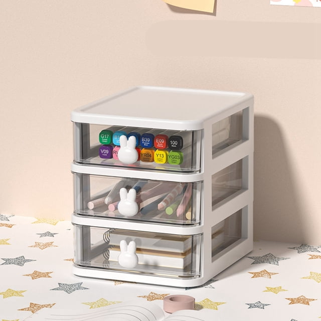Small Storage Drawers, Desk Storage Box made of durable plastic with a multi-tier design and transparent drawers. Features three compartments with bunny-shaped handles, ideal for organizing pens, books, tapes, and other office supplies. Shown on a desk with a star-patterned surface.