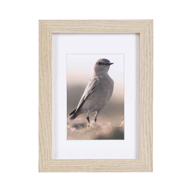 hometrends Gallery Natural Picture Frame in light natural wood finish, displaying a vertical 5x7 photo of a small bird standing on the ground, with a white mat and glass cover, includes easel for tabletop and hangers for wall display, suitable for home or office décor.