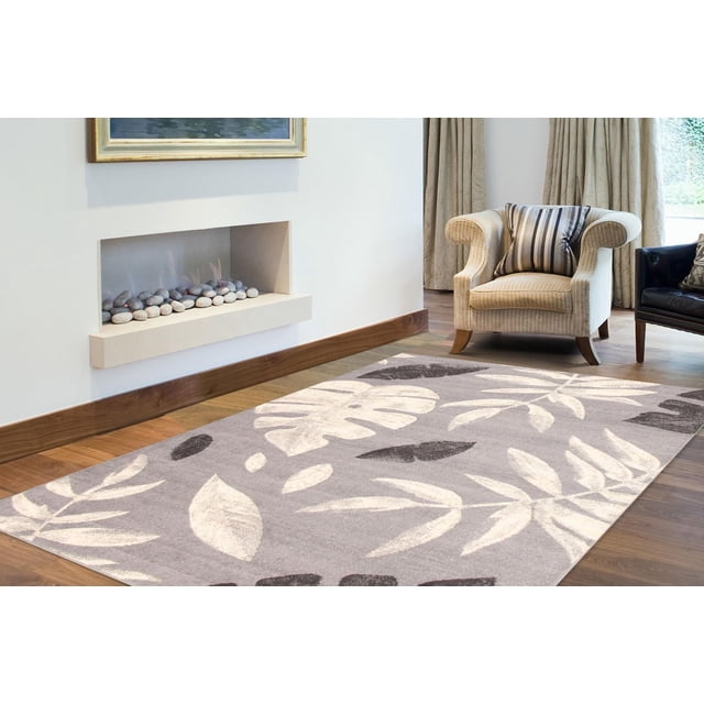 ECARPET Floral Area Rug for Living Room, Bedroom, Nursery, Kids Room, Presly Collection with a modern floral design featuring cream and dark gray leaves on a muted gray background, placed on hardwood flooring near a beige armchair and a built-in wall fireplace, ideal for enhancing kids' room decor.