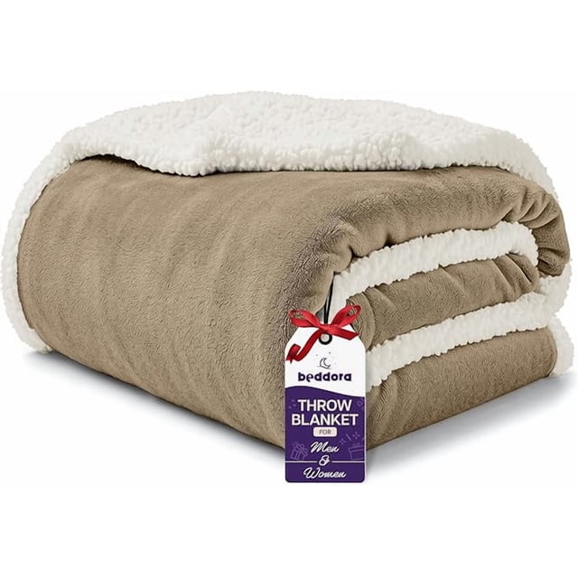Beddora Luxury Flannel Sherpa Throw Blanket, measuring 50” x 60”, shown folded with a light grey flannel top and white sherpa reverse. This ultra-soft, 450 GSM plush reversible fleece blanket is ideal for couch snuggles, bed layering, or cold weather comfort. A product tag with the Beddora logo is attached.
