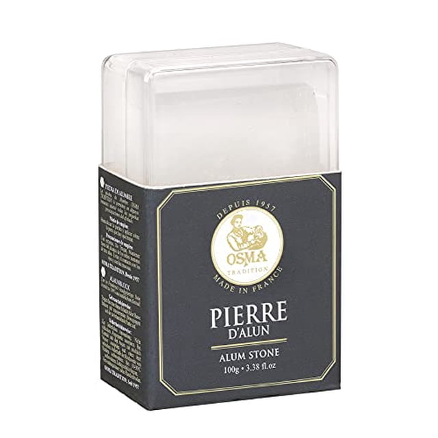 OSMA Alum Block in Plastic Travel Container 3.38 fl.oz/100g. A natural alum stone made in France, designed to calm shaving irritation and seal minor cuts. Packaged in a clear plastic case with a black and gold label featuring the Osma logo. Note: This product is categorized under household supplies but is not an air freshener.