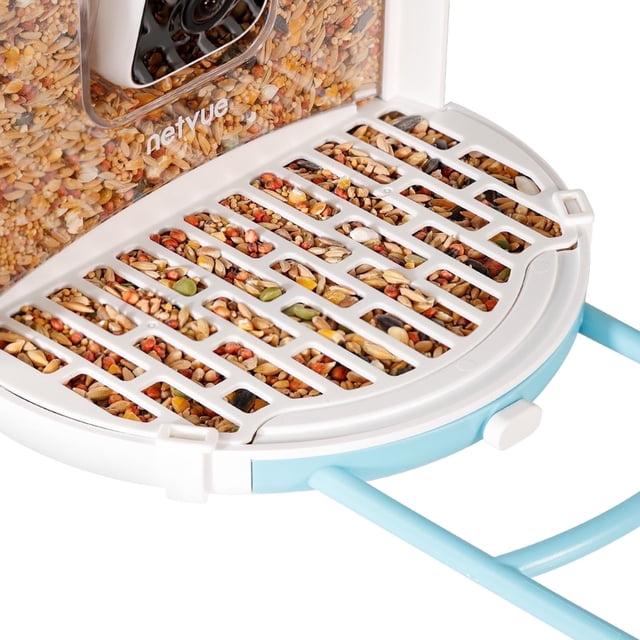 Birdfy Seed Guard, Anti-Scattering Cover Durable Waterproof for Bird Feeder, 2 Pack. A close-up of the white grid-patterned anti-scattering cover securely attached to a Birdfy feeder, effectively containing birdseed and reducing spillage caused by wind or pecking. Made from durable, waterproof material, it is easy to clean and resistant to rust. Designed to fit Birdfy smart feeder cameras, this accessory ensures a neat feeding area. Sold as a set of two covers.
