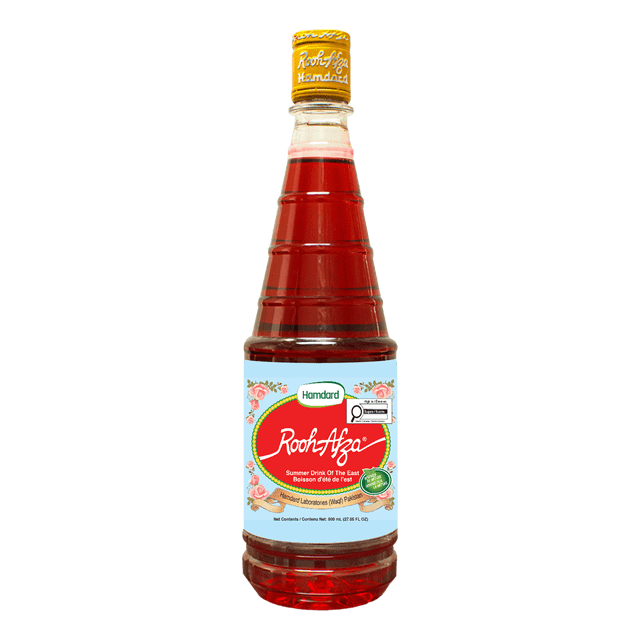 Hamdard Rooh Afza Sharbat Syrup, Rose, 25 fl.oz bottle with red rose-flavored syrup, yellow cap, and light blue label decorated with rose petals and the Hamdard brand name, suitable as a refreshing table syrup or beverage concentrate for summer drinks, puddings, and ice creams.