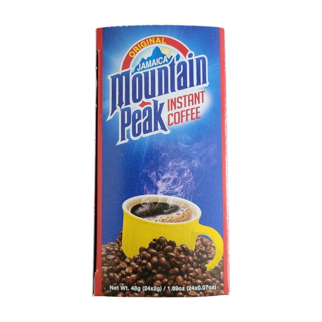 Jamaican Mountain Peak Coffee Packets (24x 2g) displayed in a vibrant red and blue box featuring the brand logo and a steaming cup of coffee in a yellow mug surrounded by coffee beans. The packaging highlights the medium roast instant coffee sachets, perfect for quick preparation and travel.