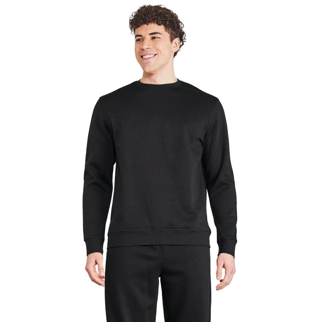 Athletic Works Men's Fleece Popover in black with crew neckline, long sleeves, and ribbed trim at neckline, cuffs, and hem. Made from a soft polyester-cotton fleece blend, shown front-facing on a male model wearing matching black fleece joggers, ideal for warmth during casual or outdoor wear.