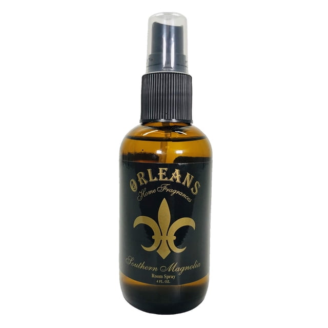 Orleans Home Fragrances 4oz Room Spray in Southern Magnolia scent, presented in a sleek amber glass bottle with a black spray nozzle and gold fleur-de-lis design. Ideal for freshening rooms, offices, cars, and linens with a long-lasting, clean fragrance. Made in Texas.