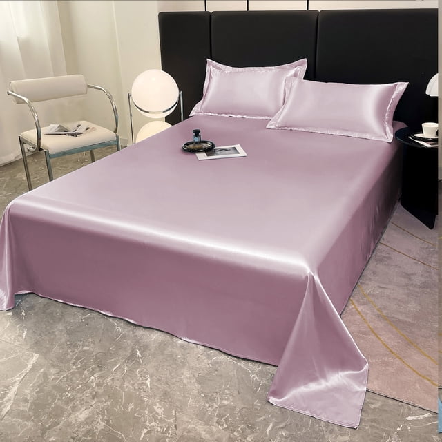 EGNMCR Ice Silk Bed Sheet Pillow Case 3 Piece Set featuring a luxurious soft ice silk fabric in a light lavender tone. The set includes one counterpane and two matching pillowcases, designed for all-season use. The bed sheet is displayed on a modern bed with a black headboard, surrounded by a contemporary room setting with a marble floor, a white chair, and a side table. The fabric has a smooth, satiny finish, offering a cool and breathable sleeping experience. Machine washable and resistant to fading, this set is ideal for dorms, RVs, or home use.