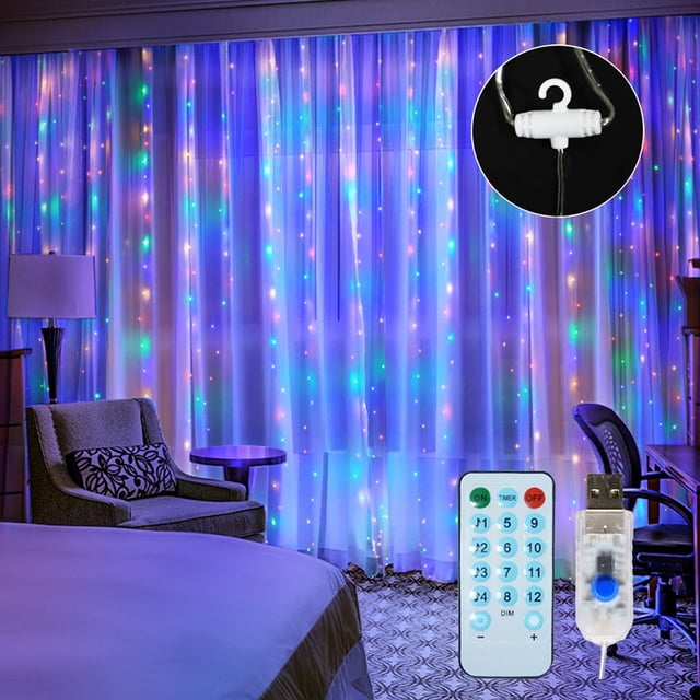 Amdohai 10 X 10FT 300LEDs Curtain String Lights Curtain Fairy Lights displayed in a bedroom setting. The multicolour LED lights are draped over a curtain, creating a vibrant and dynamic ambiance. The image also shows a remote control and USB power adapter, highlighting the product's features such as remote control functionality and USB power supply. Suitable for indoor and outdoor use, these lights are ideal for parties, festivals, and decorative purposes.