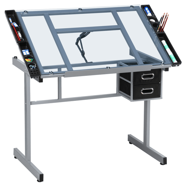 Yaheetech Adjustable Drafting Drawing Craft Table with a silver powder-coated steel frame and tempered glass top. The tabletop adjusts from 0–60° and includes a pencil ledge for tilted use. Features two fabric storage drawers, four side trays for supplies, and 360° swivel casters with brakes for mobility. Ideal for office furniture setups, this drafting table can function as a drawing table, light table, computer desk, or writing desk.