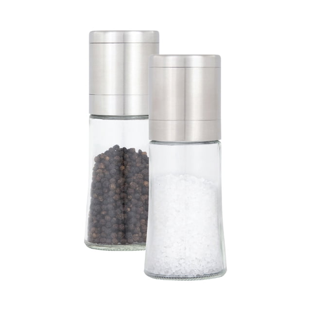 KAMENSTEIN 6.5 ELITE GRINDER SET with two glass grinders filled with sea salt and black peppercorns, featuring brushed stainless steel tops and adjustable ceramic grinding mechanisms for fine or coarse seasoning, suitable for effortless kitchen use.