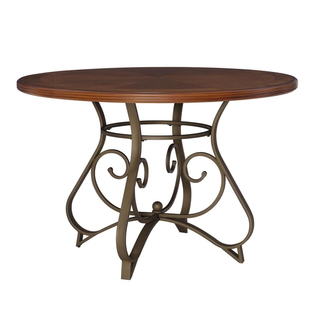 Montez Dining Table with a 45-inch round brushed faux medium cherry wood tabletop featuring a smooth surface and gently textured edge, supported by a matte pewter and bronze curved scroll metal base, suitable for kitchen and dining furniture.