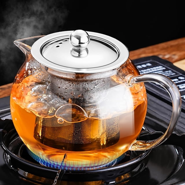 Glass Teapot Stovetop 22 OZ/650ml with a removable 18/8 stainless steel infuser, shown on a stovetop with tea brewing. Made of borosilicate lead-free glass, it is stovetop-safe, microwave-safe, and dishwasher-safe. The ergonomic heat-resistant handle and eagle-beak spout ensure smooth pouring. Ideal for brewing loose leaf tea, blooming tea, or herbal tea, with a capacity of 2 to 4 cups.