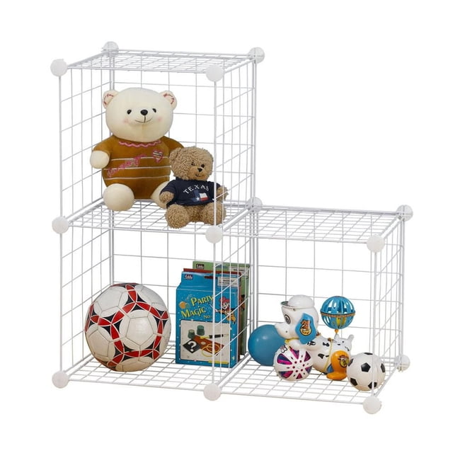 Mainstays Wire Cube White Storage Organizer, 3-cube metal grid unit assembled in an L-shape with two cubes stacked on the left and one on the right, holding toys including two teddy bears, a red and white soccer ball, a board game, and assorted small balls and figurines, made of white metal wire with plastic connectors, ideal for organizing children's rooms or play areas.