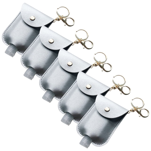 Dvkptbk Hand Sanitizer Packet Portable Disposable Pouch Outdoor Key Holster 5Pcs Travel Equipment. A set of five portable pouches made of double-sided leather in a sleek design, each featuring a refillable 30 ml bottle with a flip cap. The pouches are equipped with gold-tone keychain clasps for easy attachment to bags or keys, ideal for carrying hand sanitizer, shampoo, or lotion. The pouches are shown in a uniform arrangement, highlighting their compact size and practicality for travel or daily use.