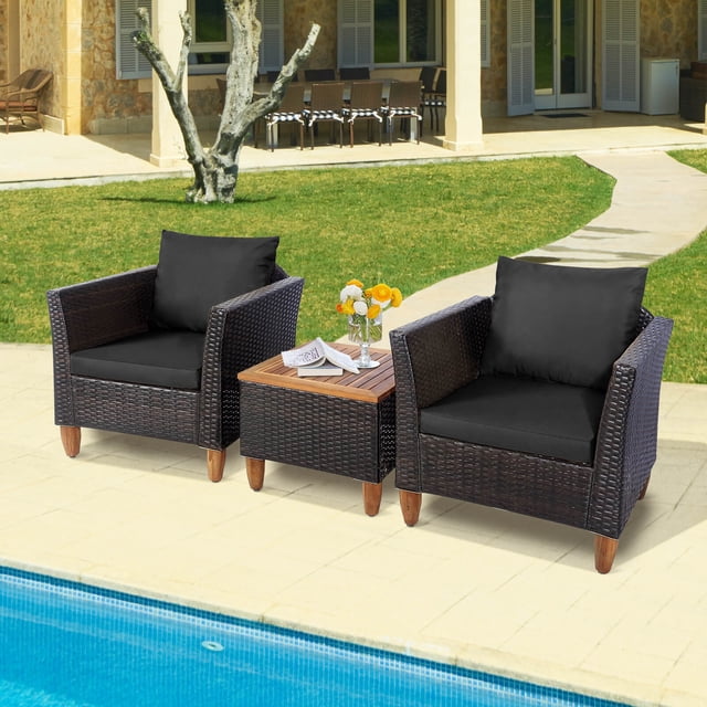 Costway 3PCS Patio Wicker Rattan Sofa Set Furniture Outdoor Acacia Wood Conversation featuring two single sofas with black cushions and a square coffee table with an acacia wood tabletop. The set is placed on a patio near a pool, showcasing its weather-resistant PE rattan and sturdy steel frame. Ideal for outdoor spaces like patios, gardens, or poolside areas.