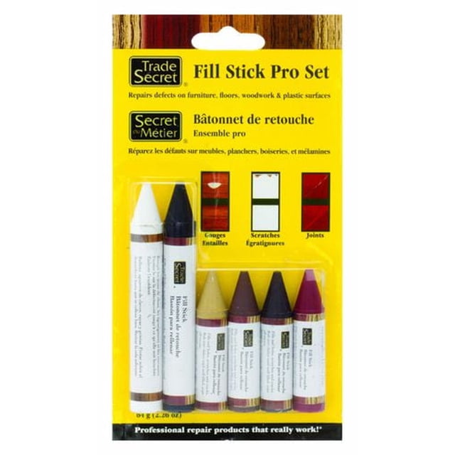 Trade Secret Fill Stick Pro Set featuring six 100% wax fill sticks in popular wood tones plus black and white, packaged on a yellow backing card, ideal for repairing furniture, floors, woodwork, and plastic surfaces by filling gouges, scratches, and joints with a shrink-resistant, colourfast wax formula.