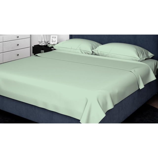 Johnson Home 500 Thread Count Combed Cotton Sheet Sets in sage green on a navy upholstered bed with headboard, featuring a smooth flat sheet and two matching pillowcases, set in a bedroom with a black nightstand and white dresser, suitable for breathable, year-round comfort.