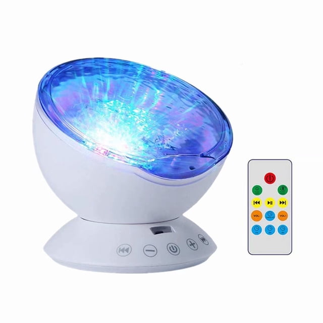 Ocean Wave Projector 12 LED Remote Control Undersea Projector Lamp with a white base featuring touch sensor buttons and a tilted projection panel emitting multicolored ocean wave effects. Includes a remote control for adjusting 7 color-changing modes, volume, timer, and music playback. Ideal as a night light, music player, or decorative lighting for bedrooms, living rooms, and festive occasions.