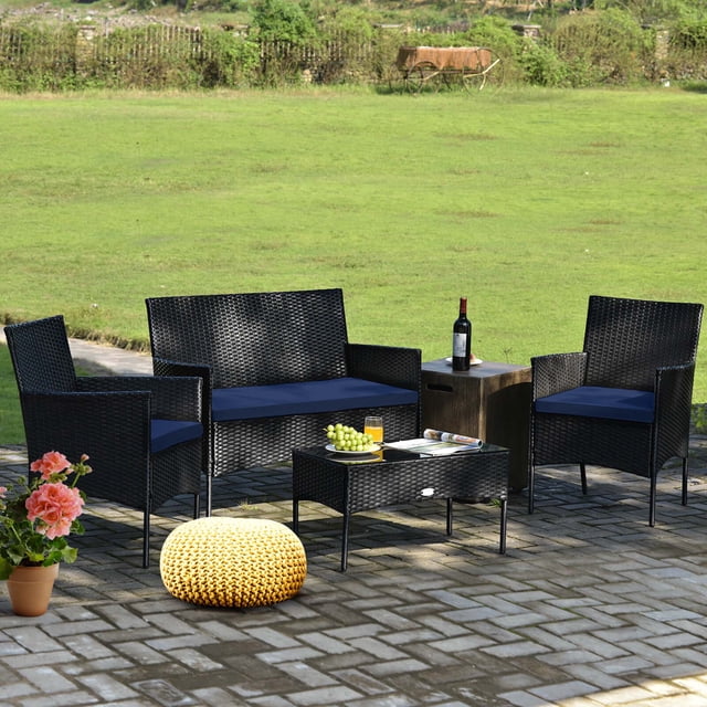 Costway 4 PCS Patio Rattan Furniture Set Cushioned Sofa Coffee Table Backyard Porch Navy. This outdoor patio conversation set includes a loveseat, two single chairs, and a coffee table, all made from weather-resistant PE rattan with a reinforced steel frame. Navy cushions offer comfort, and the tempered glass tabletop ensures durability. Suitable for backyards, porches, balconies, and poolside areas. Often used for outdoor gatherings or casual dining setups.