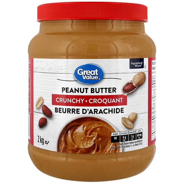 Great Value Arachide Croquante Butter dans un Pot Transparent de 2 kg avec Couvercle Rouge, Mettant en Vedette le logo Great Value et le Symbole Ingredient Wise, des illustrations d'Arachides, et des Faits Nutritifs Montrant 90 calories et 1 Gramme de Sucre par Portion, Convient pour la Collation Consciente, la Cuisine et comme base pour sauces Ou Produits de Boulangerie.
