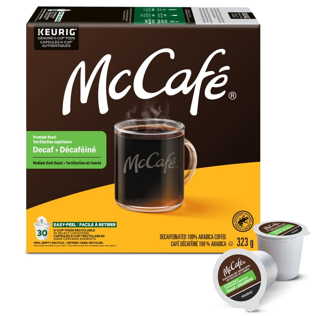 McCafé Premium Medium Dark Roast Decaf K-Cup Coffee Pods box with 30 recyclable pods, featuring a clear glass mug of steaming black coffee with McCafé logo, made from decaffeinated 100% Arabica beans using Swiss Water process, compatible with all Keurig brewers, Rainforest Alliance Certified.
