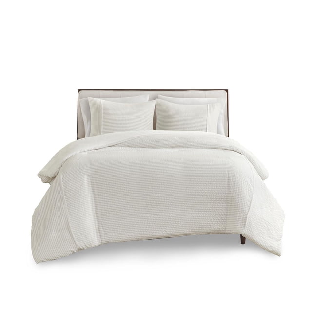 Apollo 3 Piece Striped Seersucker Oversized Duvet Cover Set displayed on a bed with white seersucker fabric featuring subtle stripes, a soft microfiber reverse, hidden button closure, and includes one oversized duvet cover with two matching standard shams, suitable for enhancing bedroom comfort.