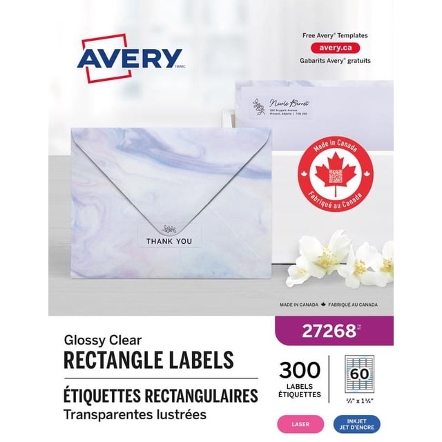 Avery Rectangle Clear Labels with Easy Peel, ⅔" x 1¾", permanent adhesive, shown on a marbled envelope flap with a floral icon and 'THANK YOU' text, compatible with laser and inkjet printers, includes 300 glossy clear rectangular labels made in Canada, displayed with a white envelope featuring a printed address label and a red maple leaf 'Made in Canada' emblem, suitable for professional mailings and personalized labeling.