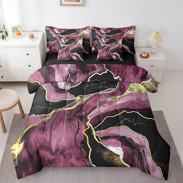 YST 7-Piece Marble Comforter Set in full size displayed on a bed. The bedding features a modern abstract art design with a vibrant marble pattern in shades of pink, black, and gold metallic accents. Includes a comforter, flat sheet, fitted sheet, two pillowcases, and two throw pillow covers. Perfect for kids' bedding, the set is styled in a bright, minimalist bedroom with a white nightstand and lamp.
