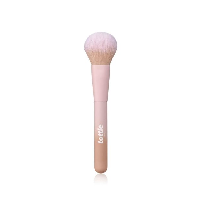 Lottie London - Multi-Use Face Brush - 100% Vegan - LF015 with densely packed, super soft synthetic bristles in a rounded shape and a pink matte handle featuring the Lottie London logo, designed for applying and blending powder and cream face makeup including setting powder, bronzer, and blush.