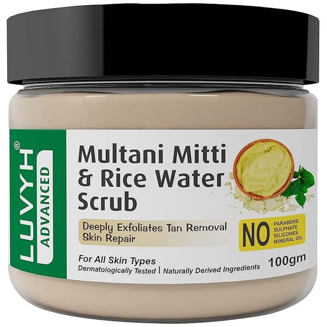 Luvyh Multani Mitti and Rice Water Face Scrub (100g) in a jar with a black lid and green label. The label highlights its benefits, including deep exfoliation, tan removal, and skin repair. This face exfoliator is suitable for all skin types, dermatologically tested, and free from parabens, sulfates, silicones, and mineral oil.