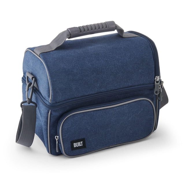 Built BLT Henery Lunch Bag in blue with durable fabric, three compartments, top carry handle with grip, removable grey cross-body strap, and exterior zippered pocket with BUILT logo, designed for organized meal storage and portability.