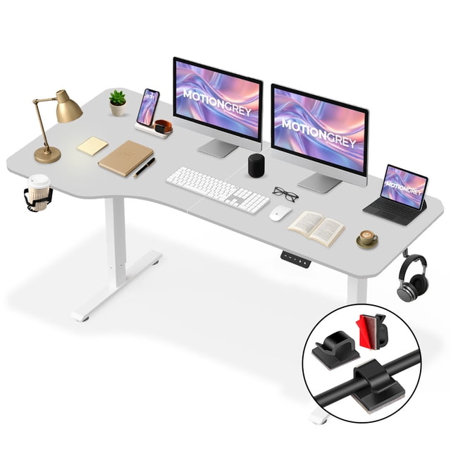 MotionGrey Ergo2 XL Adjustable Left L-Shaped Electric Standing Desk with Memory Settings, featuring a 63"x24" white MDF top and white steel frame. This ergonomic corner desk includes a memory control panel with two preset heights, a cup holder, a hook, and cable clips. Designed for home and office use, it supports up to 176 lbs and accommodates users 5’ to 7’ tall. The image shows the desk setup with dual monitors, a laptop, and accessories, highlighting its adjustable height and organized design.