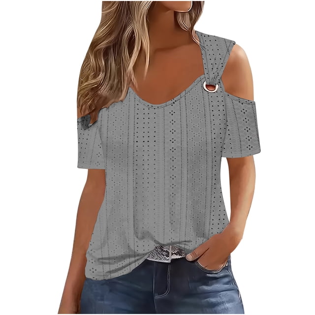 Timegard Women's Eyelet Tops in grey, featuring a V-neck design, short sleeves, and cold shoulder cutouts with a decorative ring detail. The blouse has a relaxed fit with a tunic length, showcasing a breathable eyelet fabric suitable for summer, spring, and fall. Styled with jeans for a casual yet dressy look.