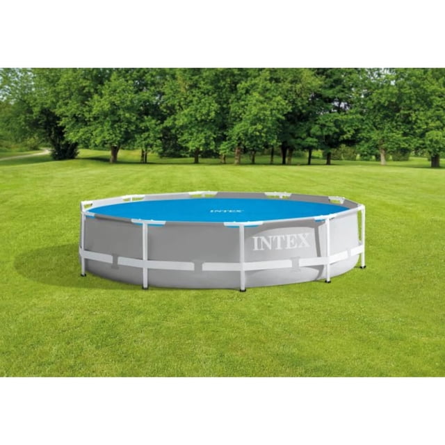 Intex 10Ft Solar Pool Cover on a round above-ground pool with a grey frame and blue solar blanket, set on a green lawn with trees in the background, designed to keep pool water warmer and reduce evaporation by up to 95%.