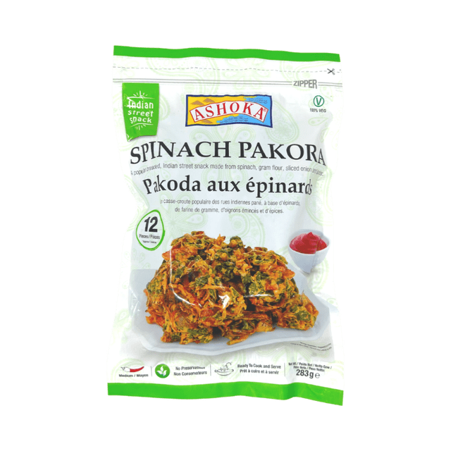 ASHOKA pakoras aux Épinards 283 g X 12 Emballage Montrant une Collation de Rue Indienne Faite à Partir d'Épinards, de Farine de Gramme et d'Oignons Tranchés, Contenant 12 Pcs. l'Avant Présente des pakoras aux Épinards Croustillants sur une Assiette Blanche avec une sauce de Trempette Rouge, Étiquetés 100 % Végétariens, Épice Moyenne, Sans Agents de Conservation, et Prêts à Cuire et à Servir, Convenant aux