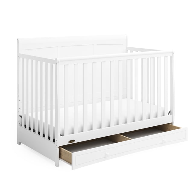Graco Asheville 4-in-1 Convertible Baby Crib with Drawer in white, featuring a traditional sleigh profile with vertical slats and paneled headboard, constructed from durable pine wood. Includes a full-size under-crib storage drawer with two compartments, perfect nursery furniture for growing children.