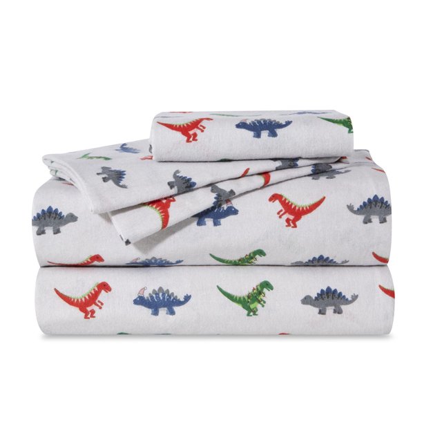Royale Flannel Sheet Sets with colorful juvenile dinosaur prints in red, green, blue, and gray on white 100% cotton flannel fabric, folded neatly, ideal for adding warmth and fun to kids' bedrooms.