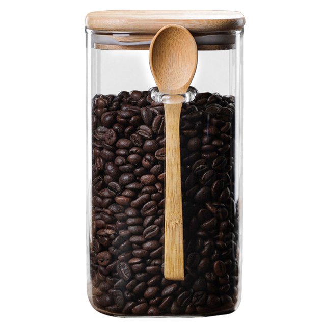 Bocal de Rangement Alimentaire en Verre, Contenant de Rangement pour Bonbons, Bocal à Grains avec Cuillère et Couvercle, Doté d'Un Corps en Verre Transparent Rempli de Grains de Café, d'Un Couvercle en Bois et d'Une Cuillère en Bois Assortie Fixée au Bocal. Ce Contenant Alimentaire en Verre Hermétique Est Idéal pour Ranger les Grains, la Farine, le Sucre, le Café, le Riz, les Noix et les Collations. Fait de Verre et de Bois Durables, le Couvercle Scelle Fermement pour Protéger le Contenu de l'Humidité.
