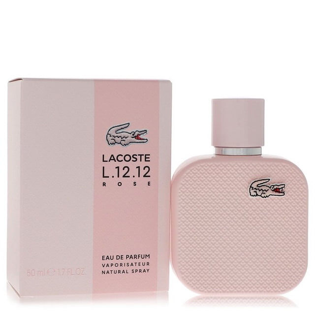 Lacoste Eau De Lacoste L.12.12 Rose by Lacoste Eau De Parfum Spray 1.7 oz for Women. The image shows a pastel pink perfume bottle with a textured surface and the iconic Lacoste crocodile logo, alongside its matching box featuring the same branding and design.