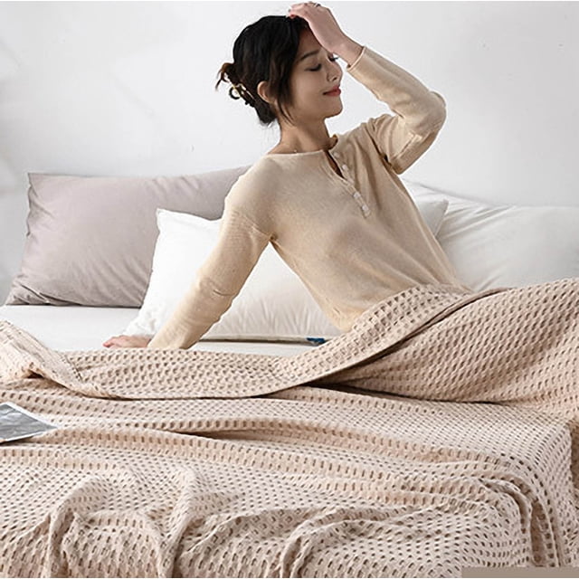 Fankiway Adult Cotton towel Blanket, a soft and breathable gauze throw blanket in a neutral tone, draped over a bed with pillows in the background. Made from 100% cotton, this lightweight and warm blanket is perfect for couches, beds, travel, or all-season use. Ideal for adding comfort and style to your home.