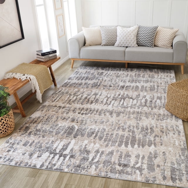 Rug Branch Cadence Animal Print Indoor Area Rug in brown beige with a modern abstract animal-inspired pattern, sized 4'x6' (3'11" x 5'7"), displayed in a bright living room with a light gray sofa, decorative cushions, wooden bench with a mustard throw, and woven basket on light wood flooring, suitable for living room, bedroom, dining room, or kitchen.